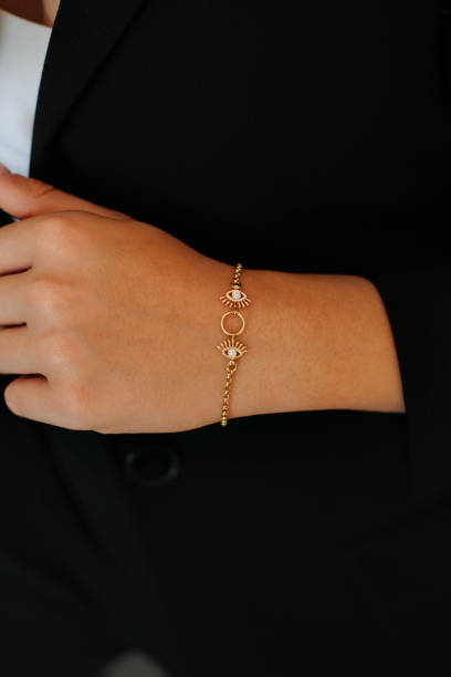 istock Women's gold bracelet in woman's hand, 1740930314