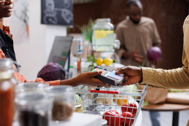 istock Customer pays with debit card at counter 1740932650