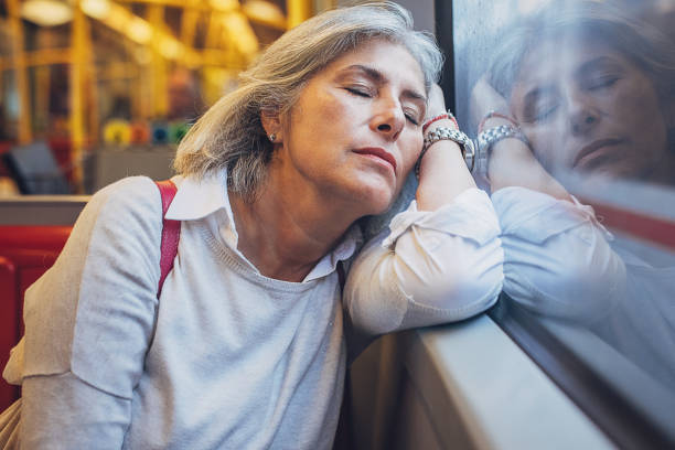 istock Woman napping in public train 1740938863