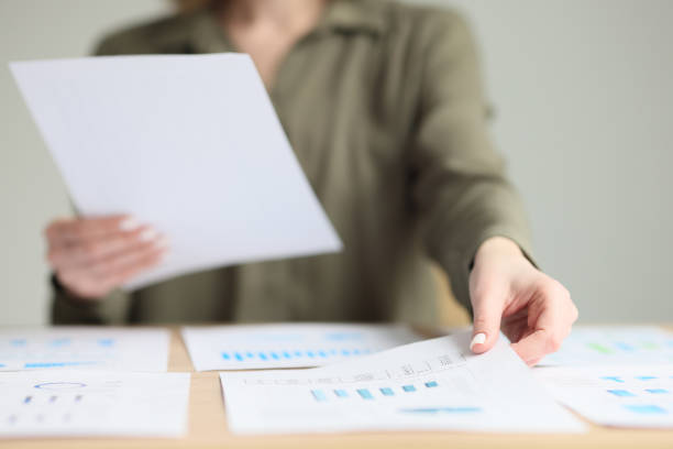 istock Secretary sorts investigation papers at workplace in office 1740942216
