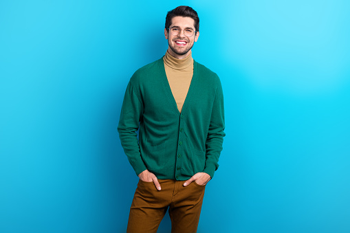Photo of positive good mood man wear green cardigan spectacles smiling isolated blue color background.