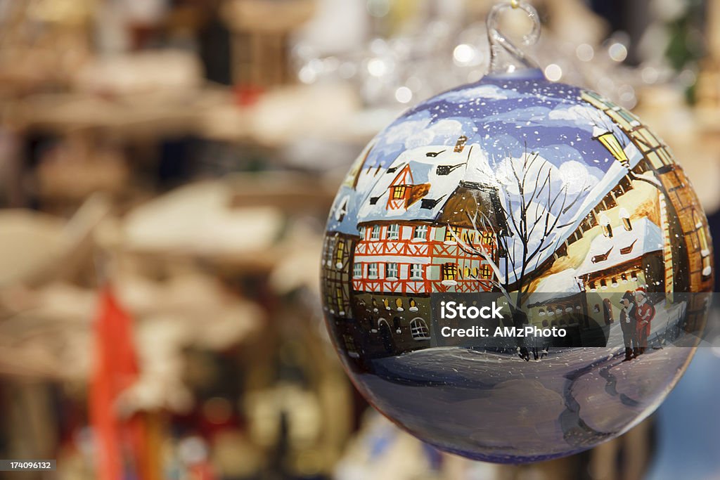 Christmas bauble depicting snowy German street Christmas ornament at a Christmas market painted with a winter scene of a German village Christmas Market Stock Photo