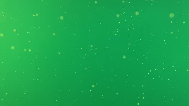 There are many dots floating in the underwater world against a green background.