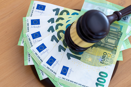 Judge or Auctioneer Gavel On 100 Euro Cash, Close-Up. Concept for corruption, bankruptcy, auction crime, fraud, fines