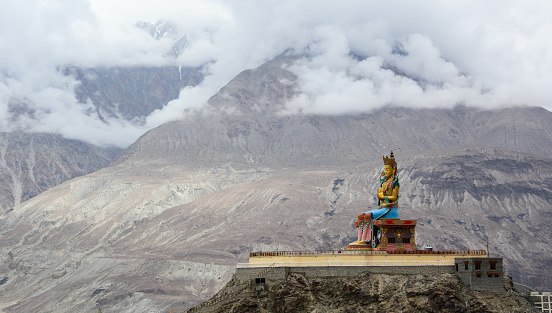 Maitreya Buddha statue with Himalaya mountains on Nubra Valley, Ladakh, India.