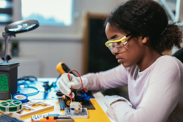 istock Girl is Working on a Robot in Her Room. Education Concept. 1740973316
