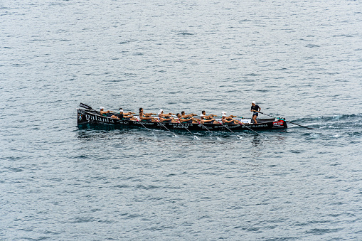 twenty man in the boat long tail on the sea. top view of man paddling