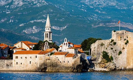 Beautiful Budva, Montenegro scenic view on ancient city from adriatic sea. Old mediterranean architecture surrounded with mountains in summer