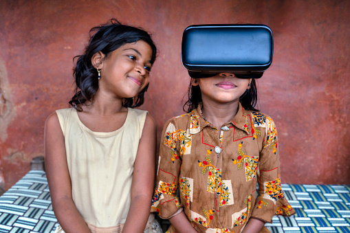 Two girls from the Kutia tribe in the Indian region of Odisha have a great time with virtual reality glasses