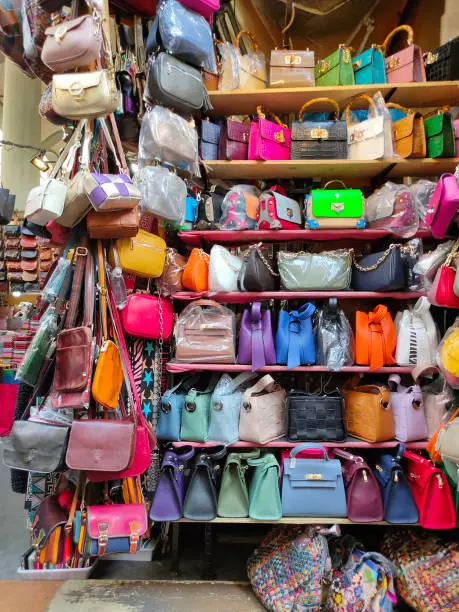 Photo of Colorful leather purses, handbags, wallets and handbags are displayed by street vendors at the outdoor Lorenzo Market at Florence, Italy.