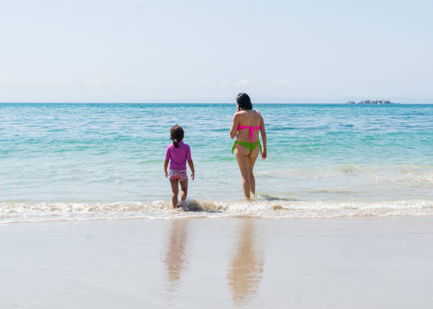 istock Latin mother and daughter on the beach 1740992500
