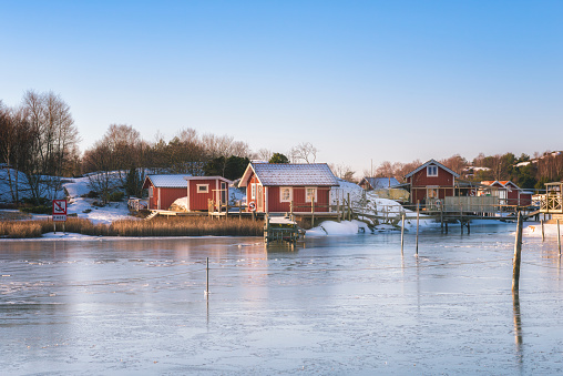 Coastal cottages at frozen island. Gothenburg, Sweden.
