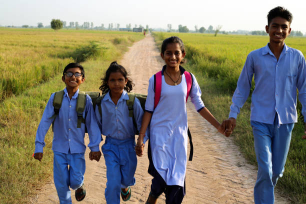istock Elementary age school students walking on country road after school vacation 1740994753