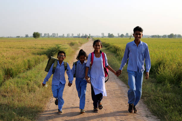 istock Elementary age school students walking on country road after school vacation 1740994774