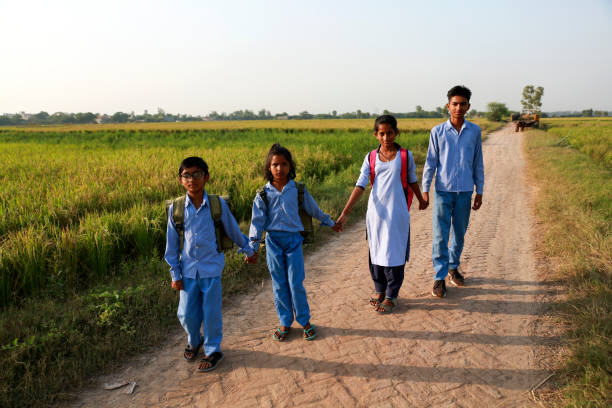 istock Elementary age school students walking on country road after school vacation 1740995888