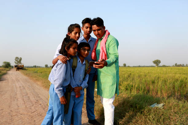 istock Farmer family using mobile phone outdoor in nature 1740995916