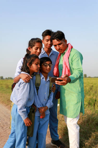 istock Farmer family using mobile phone outdoor in nature 1740995929