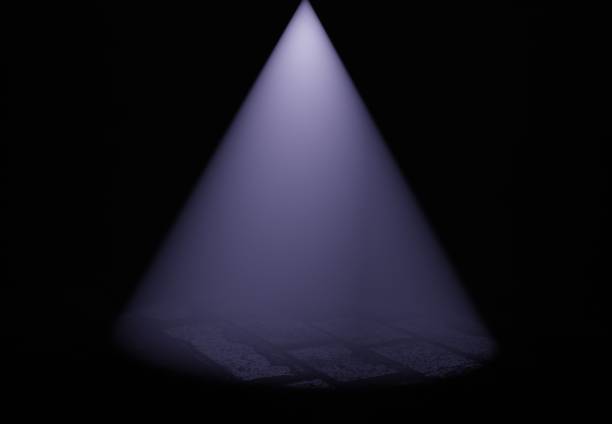istock Mystical blue cone of light illuminates brick pavement background 1741003181