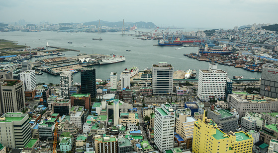 Busan, South Korea - Sep 18, 2016. Aerial view of downtown on coast in Busan, S. Korea. Beautiful scenery from Busan Tower in rainy day.