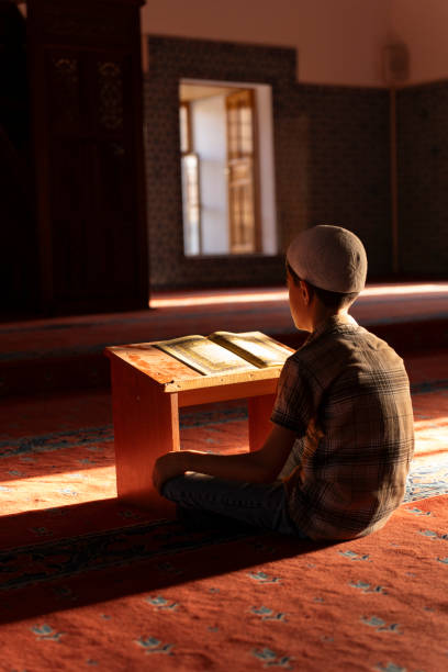 istock A boy reading the Qur'an in a mosque. 1741006648