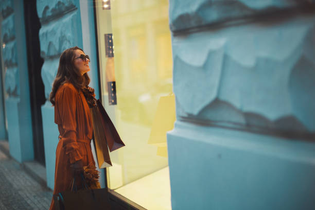 istock smiling elegant female in orange trench coat 1741015187