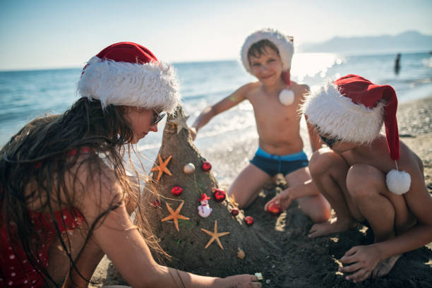 istock Kids enjoying summer Christmas on the beach 1741015867