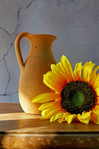 istock artificial sunflower and  old vase on the wooden table 1741027215