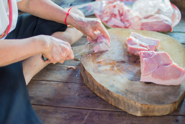 butcher cutting meat on board