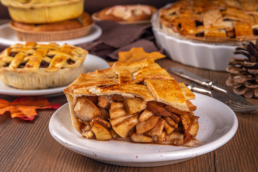 Apple Pie and apples on white wooden table