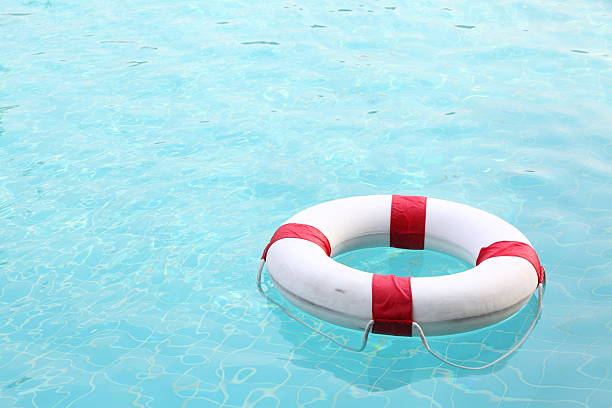 istock red and white rescue wheel on swimming pool 174104639