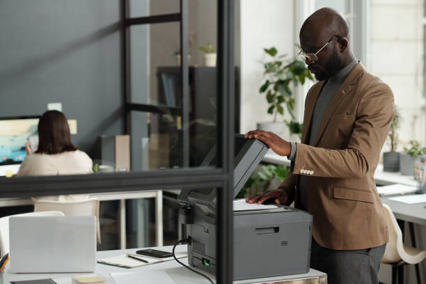 istock Confident young male chief executive officer making copies of documents 1741050794