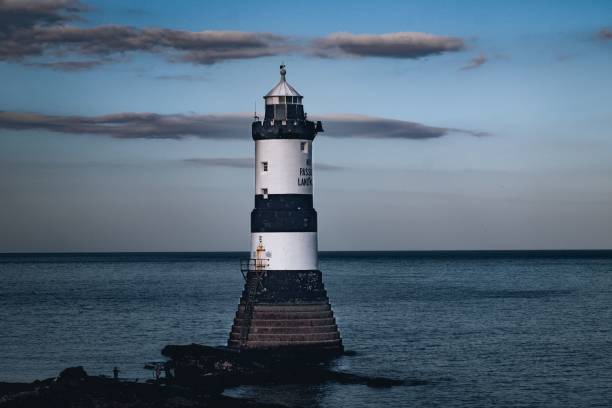 istock Idyllic Penmon lighthouse on a pier overlooking water in Anglesey, Wales 1741057249
