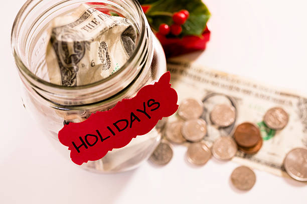 istock Christmas:  Money Jar with coins, dollar bills.  Saving for Holidays. 174105814