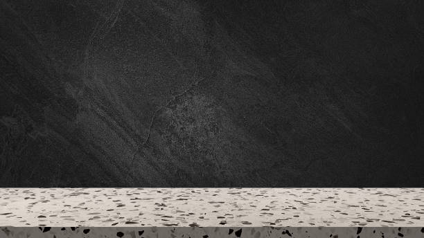 istock empty beige terrazzo marble tabletop with dark black cement stone background for product displayed in rustic mood and tone. luxury background for product stand with empty space for decoration. 1741082732