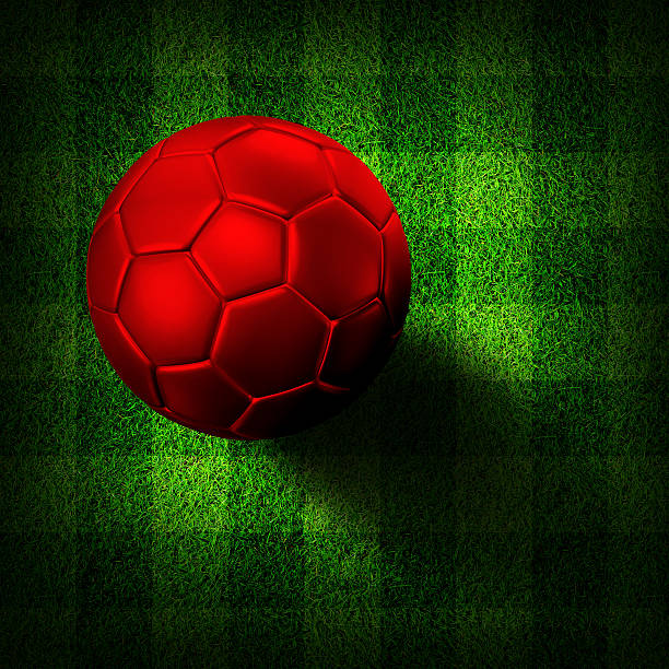 Red soccer football on grass field