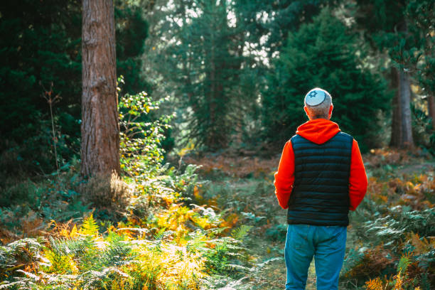 istock Jewish man wearing yarmulke walking on forest path 1741094504