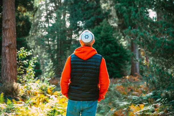 istock Jewish man wearing yarmulke walking on forest path 1741094517