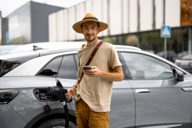 istock Man charging electric car on a public charging station 1741095040