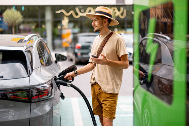 istock Man charging electric car on a public charging station 1741095063