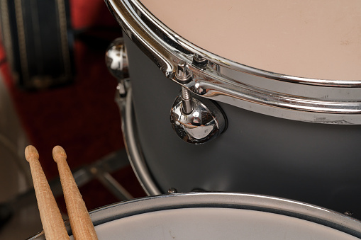 Drum sticks, snare dcrum and tom, macro photo