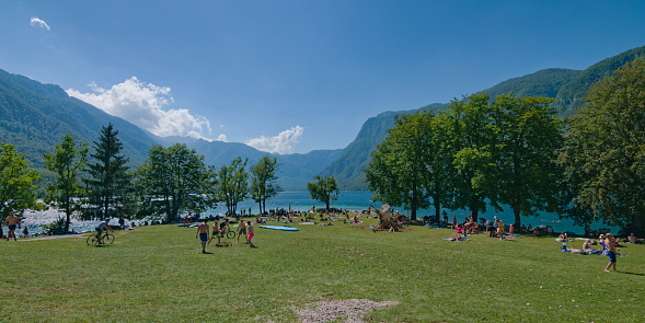Stara Fuzina, Slovenia - July 16, 2023: People are enjoying summer sunny day on the beach. Very popular tourist destination.