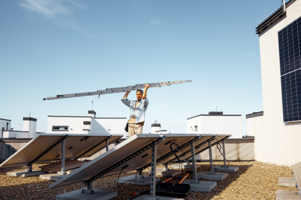 istock Man carries ladder during solar panels installation 1741105932