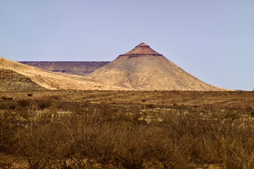 Dry mountain shapes, some flat others conical from the C14 in Namibia