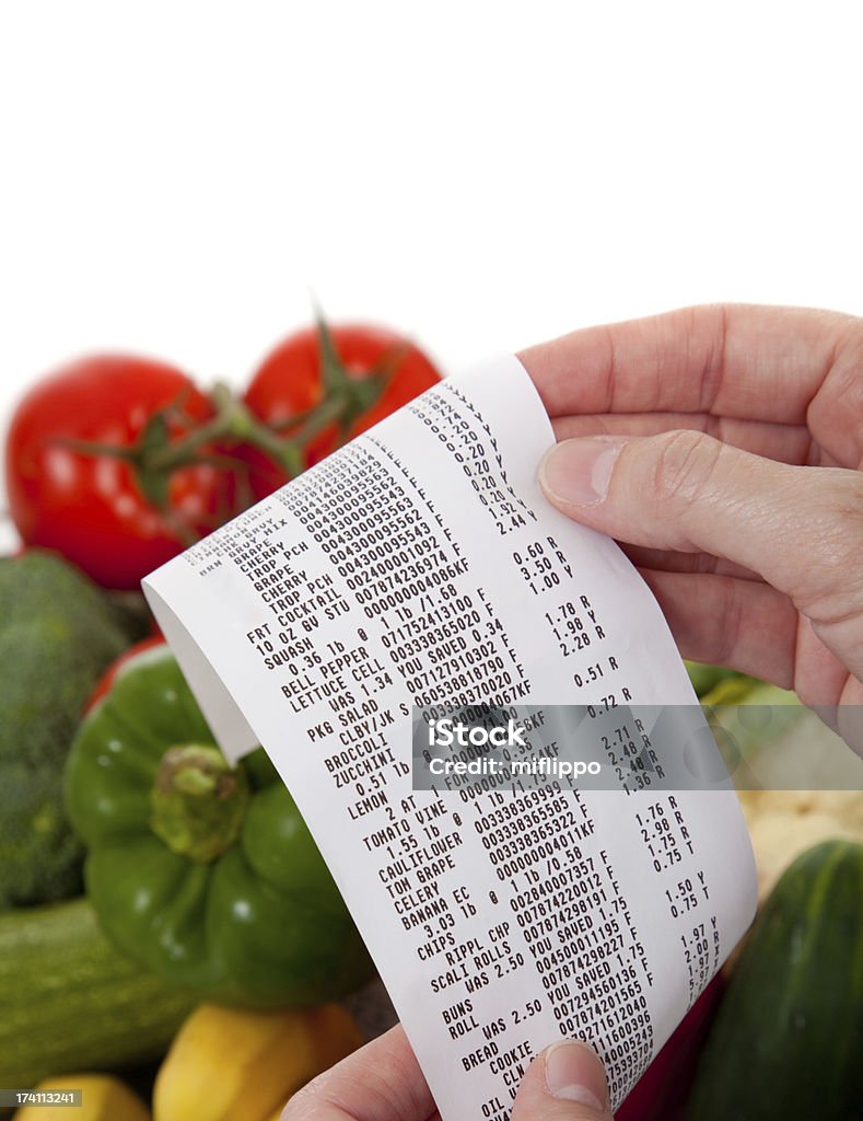 Grocery List over a bag of vegetables A Receipt over bag full of vegetables Receipt Stock Photo