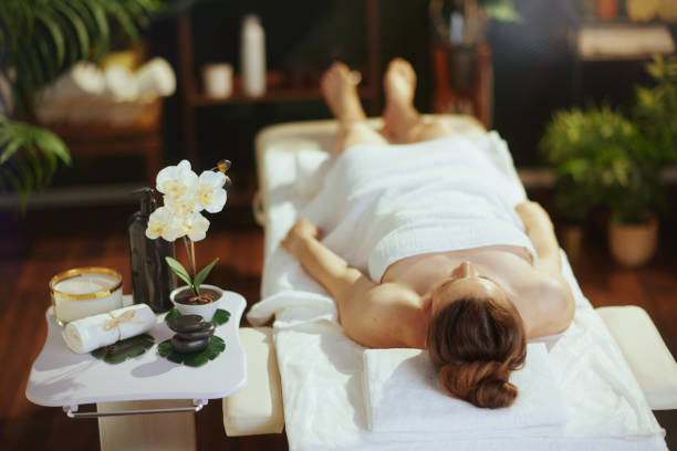 istock relaxed modern woman in spa salon laying on massage table 1741133489