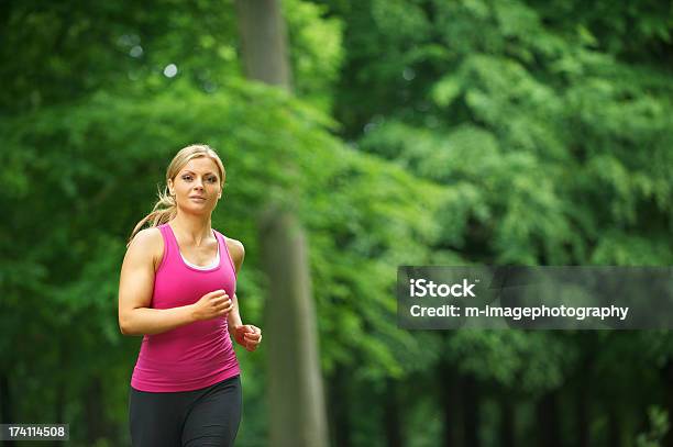 Young Woman Running In The Park At Her Leisure Stock Photo - Download Image Now - 20-24 Years, 20-29 Years, 25-29 Years