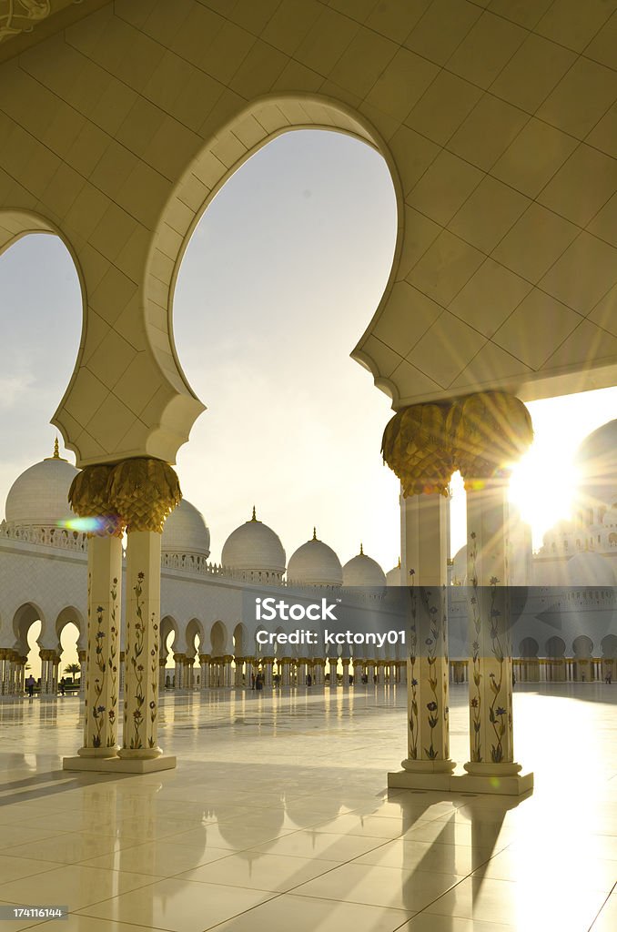 Mosque at Sunset Mosque giving out pods of gold during the sunset with reflections of the round domes. Mosque Stock Photo