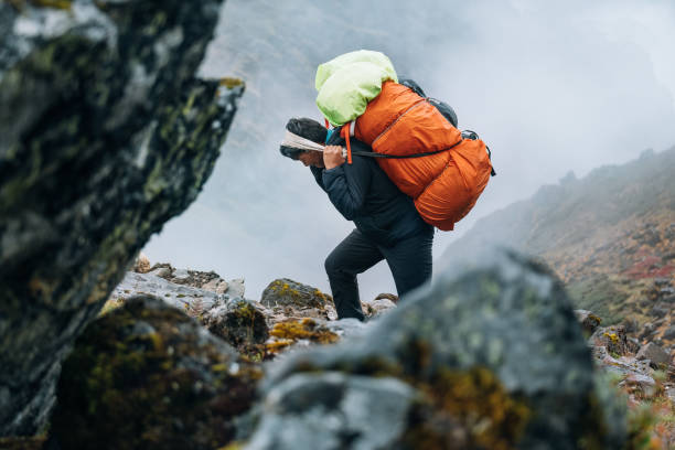istock Strong Sherpa man working as porter carrying a huge cargo with traditional method on forehead. High Himalayas expedition during Mera peak climbing. Nature, transportation or goods delivery concept 1741167945