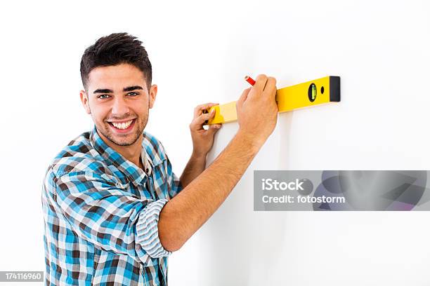 Man Using Level Home Improvement Young Man Using Level On Wall Stock Photo - Download ...