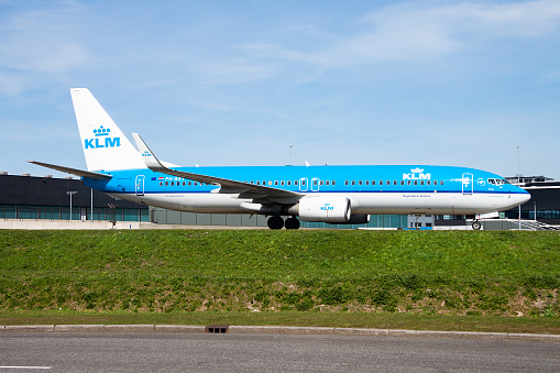 Amsterdam, Netherlands - April 12, 2015: KLM passenger plane at airport. Schedule flight travel. Aviation and aircraft. Air transport. Global international transportation. Fly and flying.